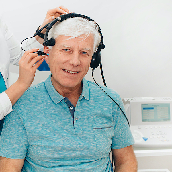 Impedance Audiometry, Diagnosis Of Hearing Impairment. An Elderly Man Getting An Auditory Test In A