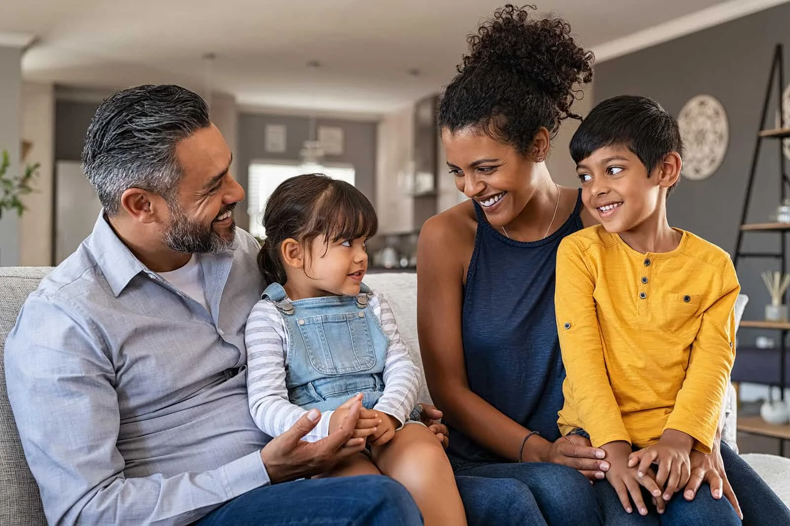bigstock-Happy-latin-family-sitting-on--391587044